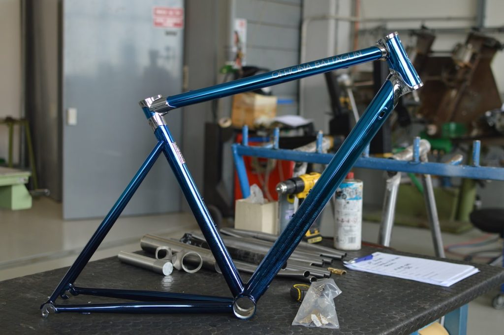 The Portofino R 2023 lugged steel frameset standing on a workbench in the Battaglin workshop